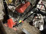 a red lawn mower that is sitting in a garage