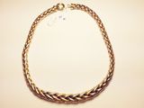 a close up of a gold necklace on a white surface