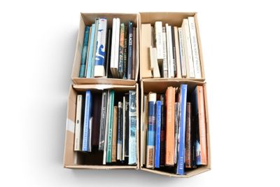 de nombreux livres dans une boîte posée sur une surface blanche