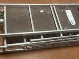 a close up of a metal rack on a wooden table