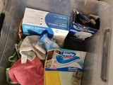 a plastic container filled with cleaning supplies on the floor