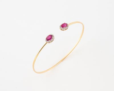 a yellow gold bracelet with a ruby stone and diamonds
