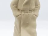 figurine of a man in a coat and hat standing on a black base