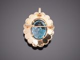 a close up of a blue topaz stone broochle on a black surface