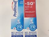 two boxes of toothpaste sitting on top of a white table