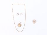 a necklace, earring, and ring on a white surface