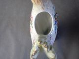 a small vase with a starfish on it on a table