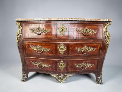 an antique chest of drawers with marble top and brass handles