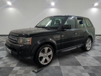an image of a black land rover parked in a garage