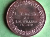 a close up of a medal on a green surface