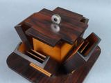 a small wooden box with a hole in it