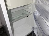 an open refrigerator with a freezer inside of it