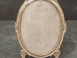an antique silver picture frame with a decorative design on it