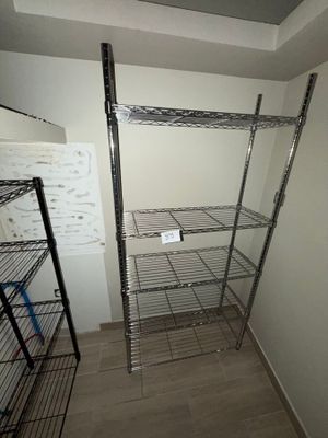 a metal shelving in the corner of a room