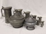 many different types of pewware sitting on a table