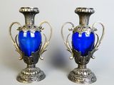 two blue vases sitting next to each other on a table
