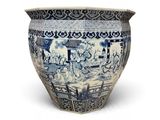 a large blue and white vase with elephants on it