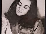 an old black and white photo of a woman with long hair