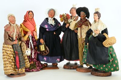 five figurines of women dressed in traditional clothing