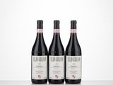 three bottles of red wine sitting on top of a table