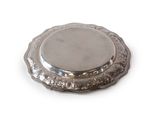a silver plate on a white surface with a white background