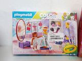 a box of playmobil and a box of crayon crayons