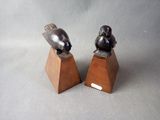 two birds that are sitting on top of each other