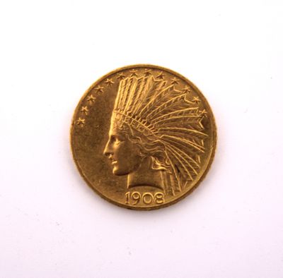 a close up of a gold coin on a white surface