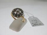 une bague sertie d'une perle et munie d'une étiquette de prix