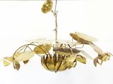 a gold chandelier with flowers and leaves hanging from the ceiling