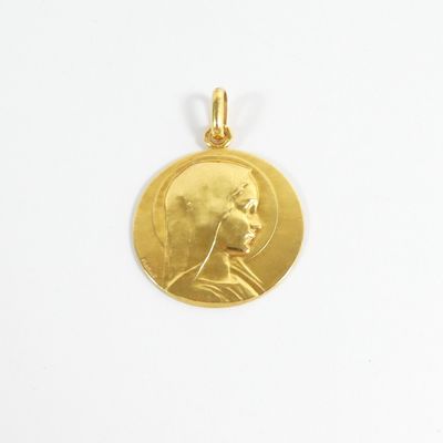a close up of a gold coin with a man ' s face on it