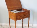 a small wooden table with a magazine on it