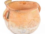 an old clay pot with a handle on a white background