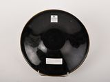 a black and white plate with a picture of a woman on it