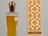 an image of a bottle of perfume next to a box on a table