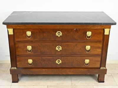a wooden chest of drawers with a marble top