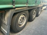 a green truck that is parked on the side of the road