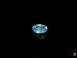 a close up of a blue diamond on a black surface