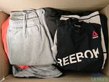a box with two pairs of sweatpants and a t - shirt