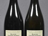 two bottles of wine sitting next to each other on top of a table