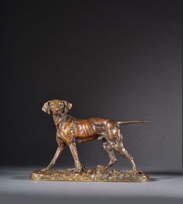 une statue en bronze représentant un chien debout sur un rocher