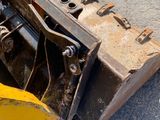 a yellow bulldozer that is laying on the ground