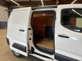 a white van with its doors open in a garage
