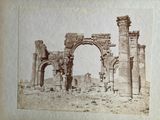 a picture of an old photo of an arch in the middle of the desert