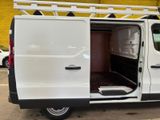 a white van parked in a parking lot with its doors open