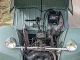a green car with a large engine in the back of it
