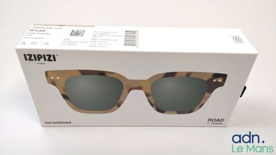 the box of a pair of sunglasses is open on a white surface