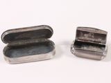two small silver boxes sitting next to each other