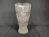 a glass vase that is sitting on a black background