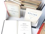 several books are sitting in a box on a white surface